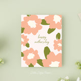 Mothers Day card that reads Happy Mothers Day in the middle with pink flowers around the outside edges on a blush background.