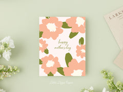 Mothers Day card that reads Happy Mothers Day in the middle with pink flowers around the outside edges on a blush background.