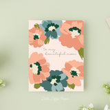 Mothers Day card that reads To My Beautiful Mom in the middle with pink and blue flowers around the outside edges on a blush background.